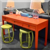 F22. Painted orange desk with 3 drawers. 30”h x 58”w x 20”d 